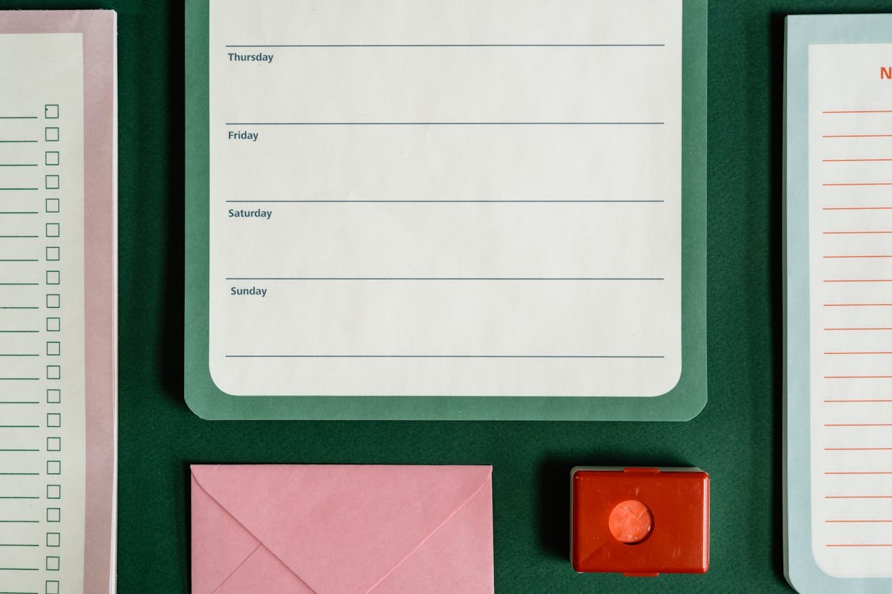 Home Flat lay of assorted stationery on a green surface, emphasizing organization.